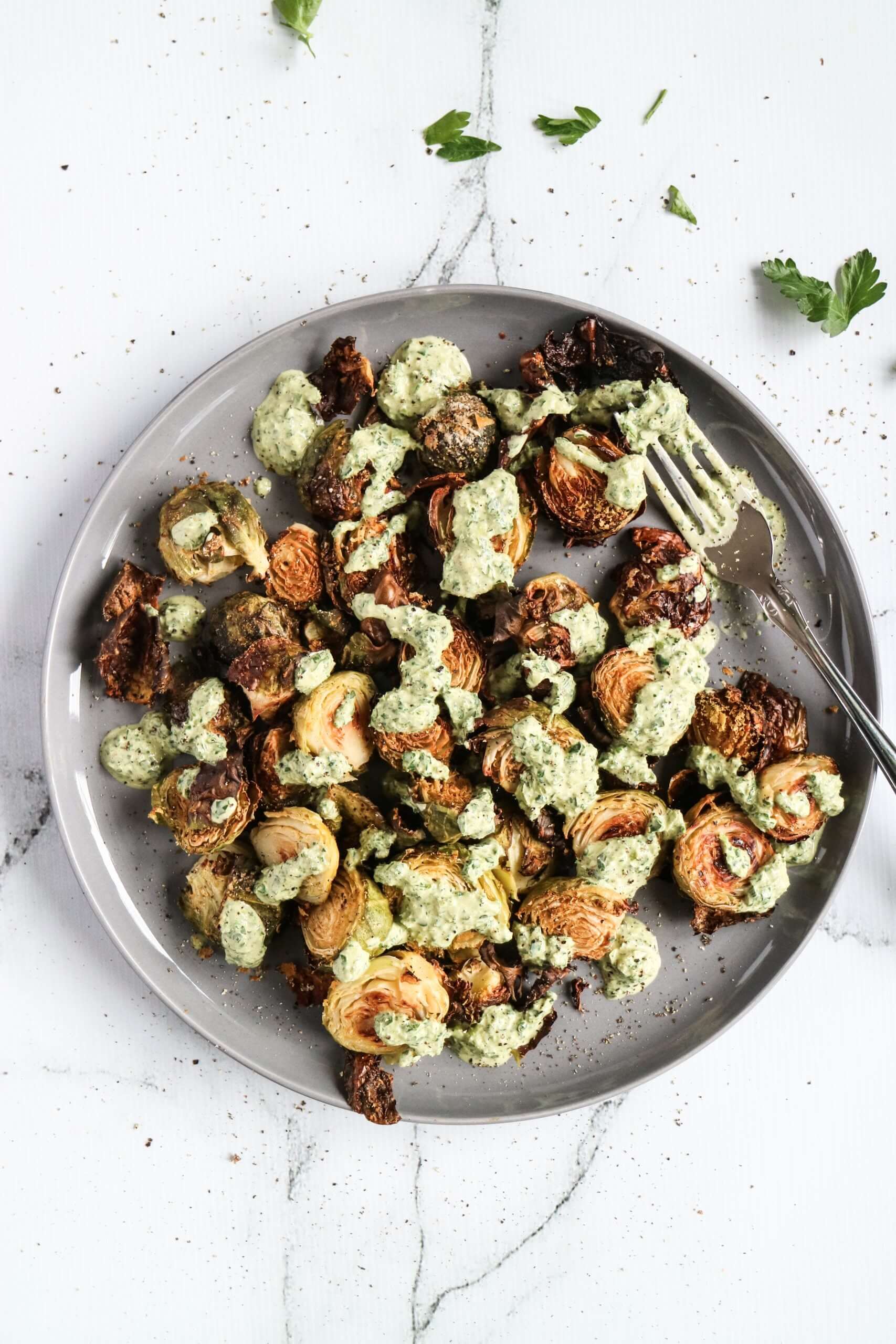 Cheesy' Roasted Brussels with a Green Tahini Sauce